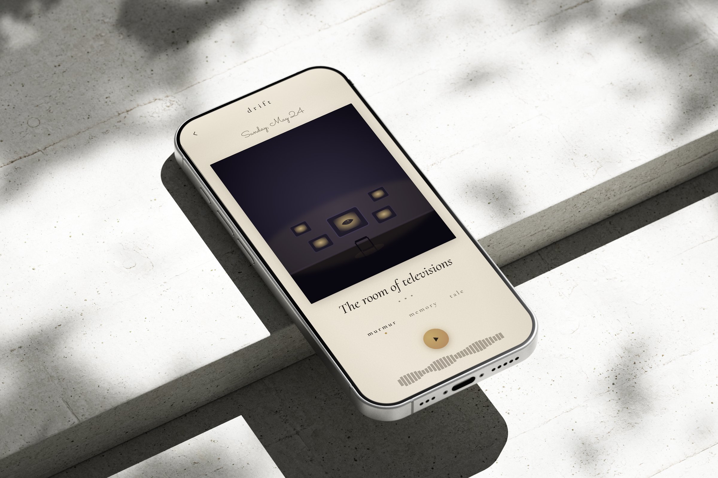 The Drift prototype — “the room of televisions” — on a phone resting on concrete