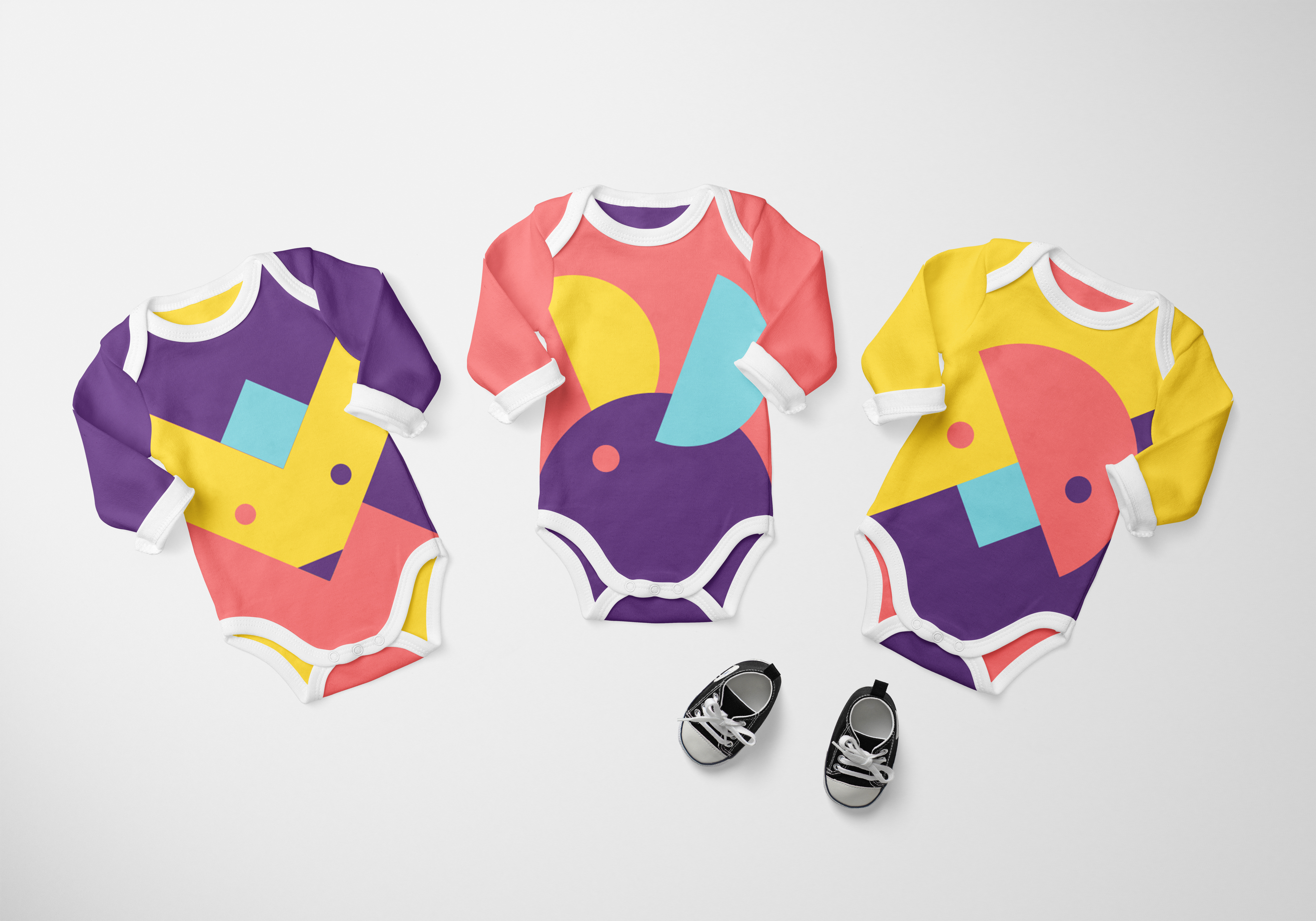 Three baby onesies featuring Kookedo's modular shape compositions